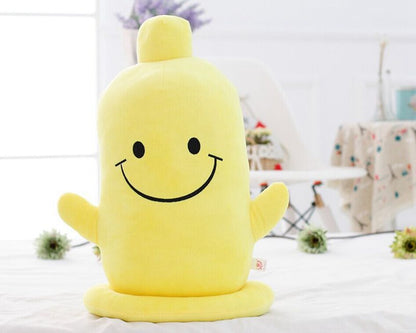 One yellow soft plush toy with smiling face, two stubby arms, rounded top and flat circular base on white bed.