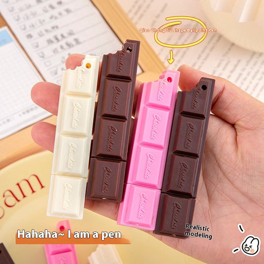 Set of three chocolate bar ballpoint pens in white, milk, and pink chocolate designs, with a playful bite taken out.