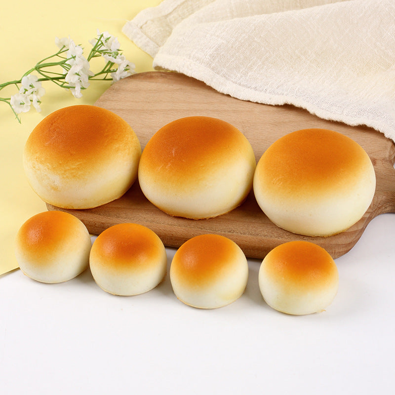 Row of golden bun squishies in two sizes