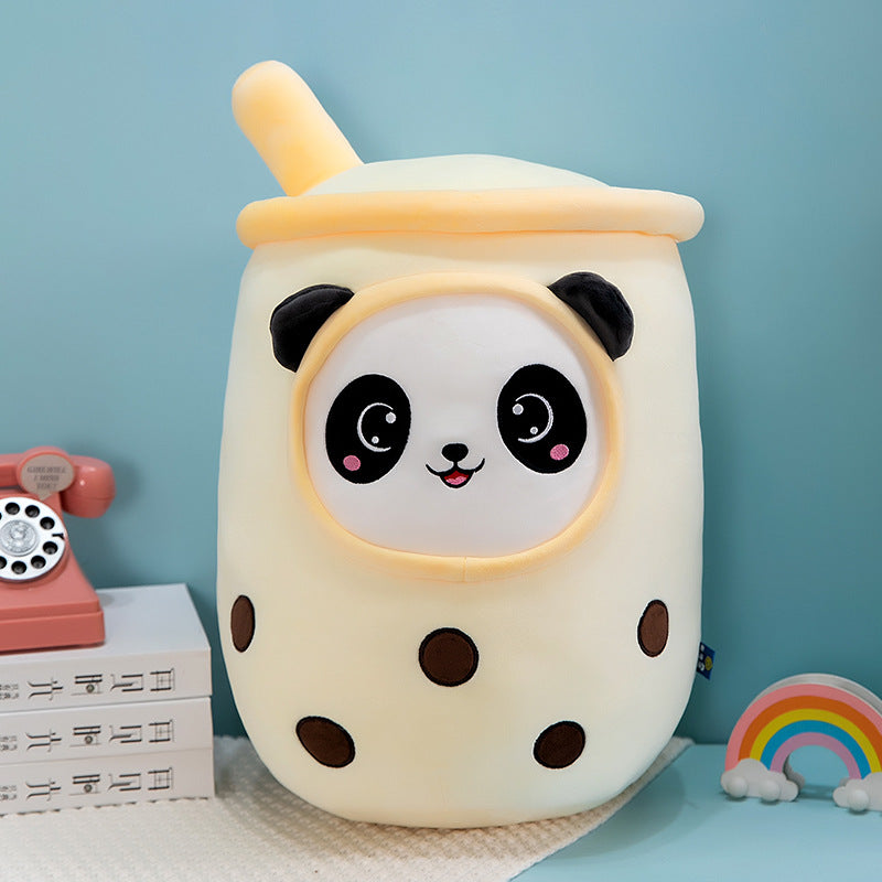 One pale yellow plush milk-tea cup pillow with panda face, black ears, brown boba dots and top straw.