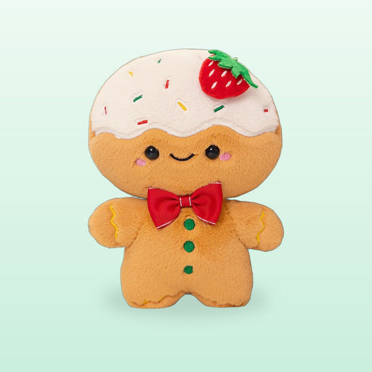 Strawberry frosted gingerbread plush with white icing and a red bow tie, on a mint background