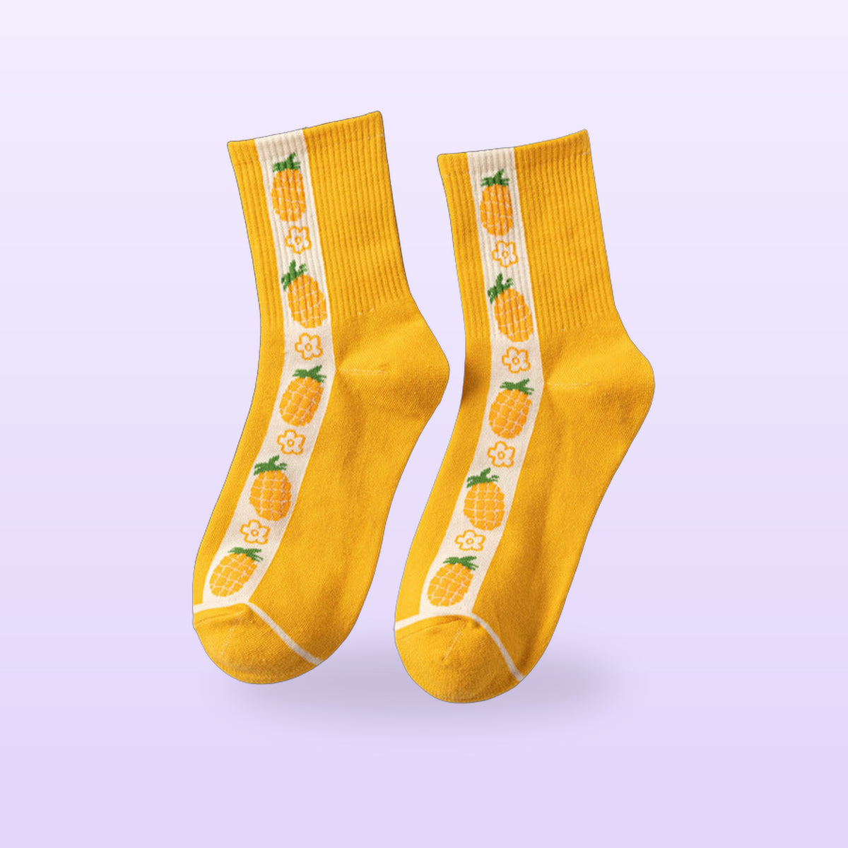 Yellow pineapple crew socks with a cream stripe of pineapples and flowers, on a lilac background