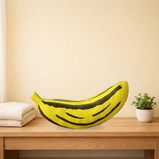 Giant banana plush cushion lying along a light oak bench
