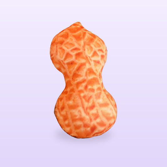 Giant peanut plush pillow with a textured shell print, on a lilac background