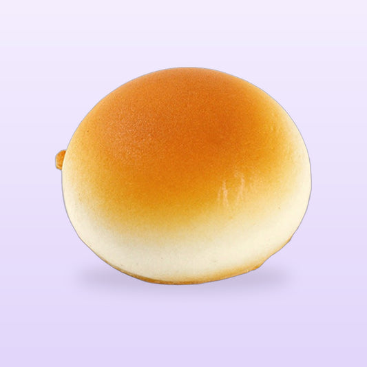 Golden glazed bun squishy, on a lilac background