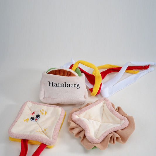 Burger pet toy beside an opened sandwich toy showing its soft layers