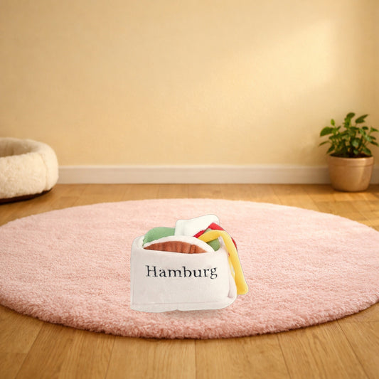 Burger snuffle pet toy on a pink rug in a living room