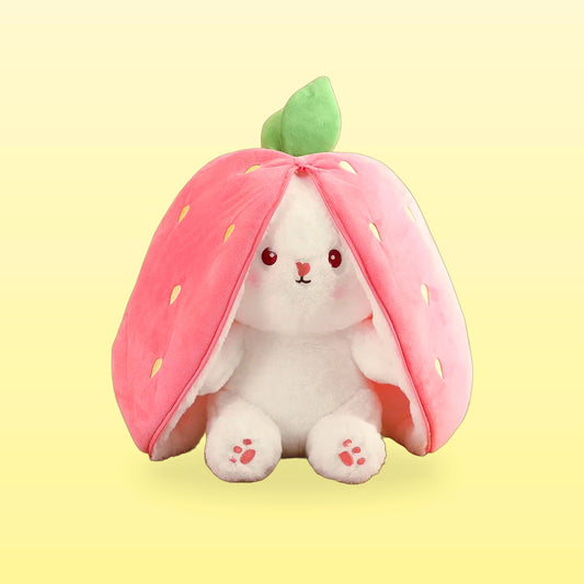 Strawberry rabbit plushie, white bunny peeking out of a pink strawberry hood, on a butter yellow background