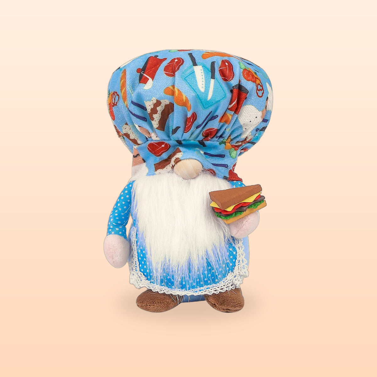 Blue chef gnome plush doll with a food print hat, white beard and a sandwich, on a peach background
