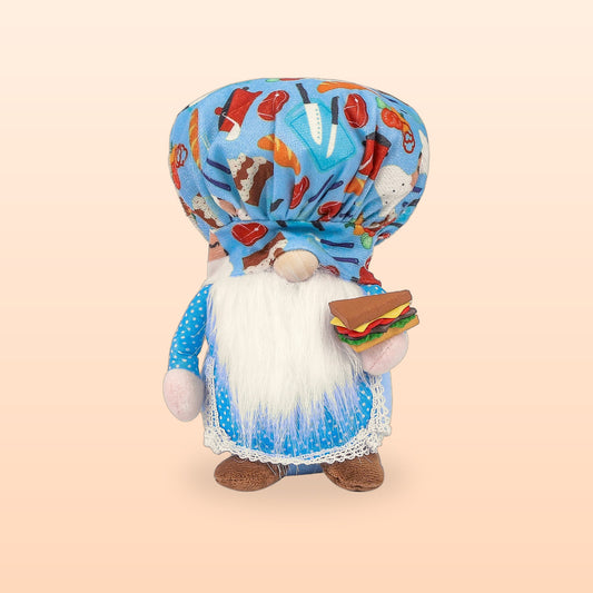 Blue chef gnome plush doll with a food print hat, white beard and a sandwich, on a peach background