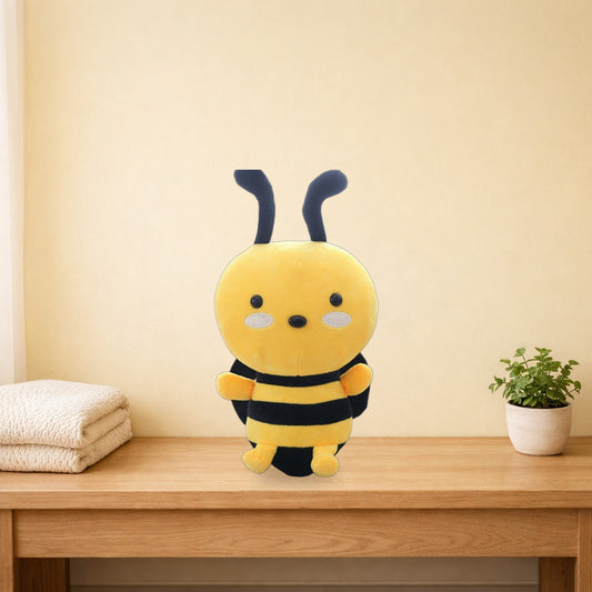 Honeybee plush toy sitting on a light oak bench