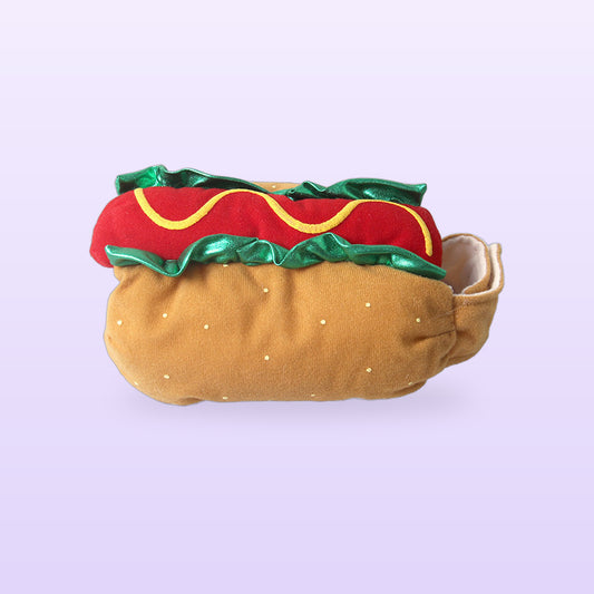 Hot dog pet costume with a bun, sausage, mustard and lettuce frill, on a lilac background
