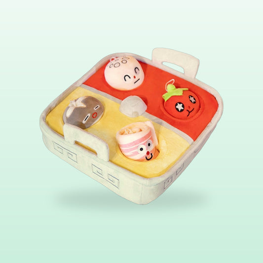 Plush hot pot playset with smiley ingredients in red and yellow soup sections, on a mint background