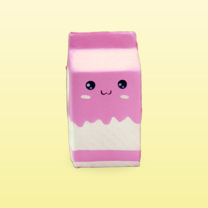 Strawberry pink milk carton squishy with rosy cheeks on a butter yellow background