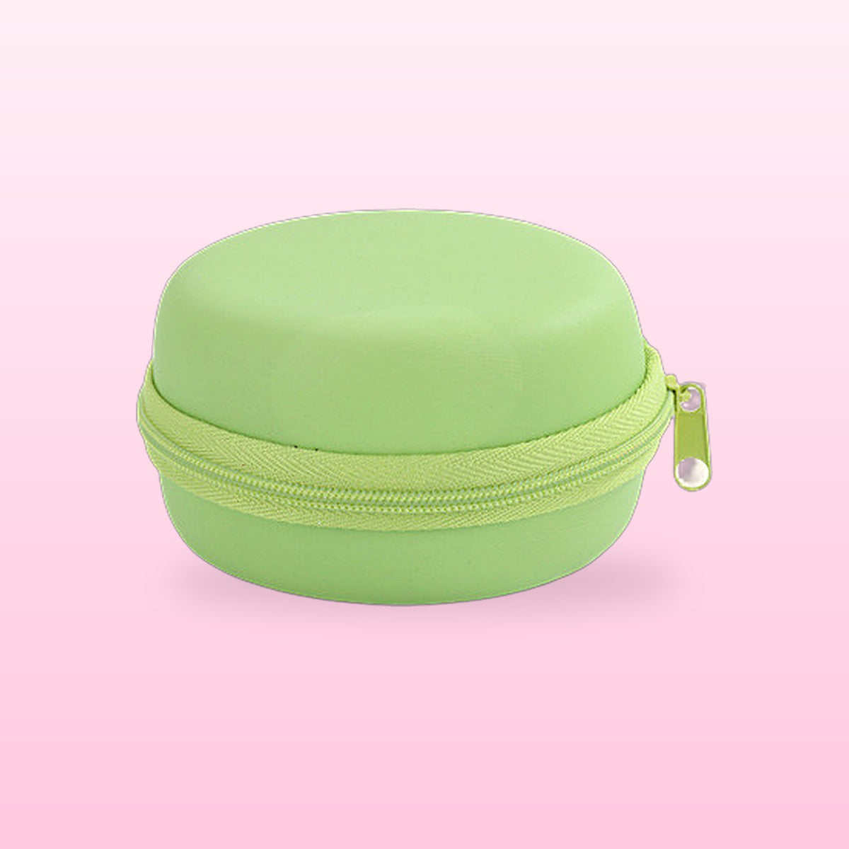 Pistachio green macaron travel jewellery case on a pink background