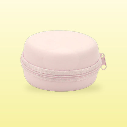 Rose pink macaron travel jewellery case on a butter yellow background