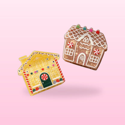 Two gingerbread house claw clips, classic brown and lemon yellow, on a pink background