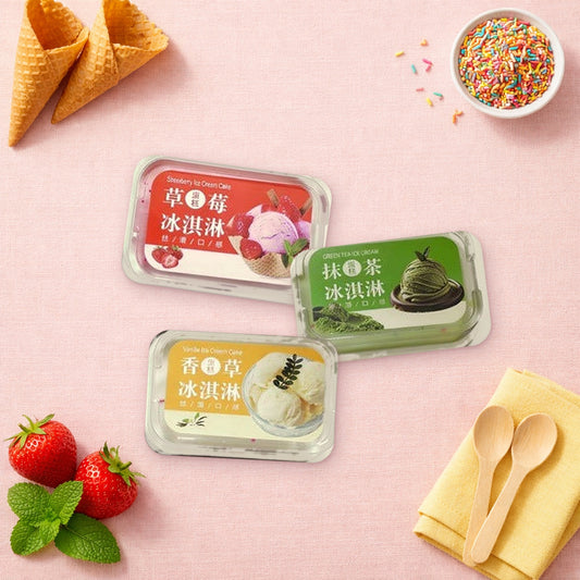 Strawberry, matcha and vanilla ice cream tub squishies on a pink table with waffle cones, sprinkles and fresh strawberries