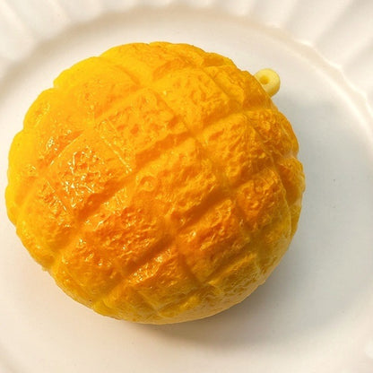 Golden pineapple bun squishy with its crackly bakery top sitting on a fluted white plate
