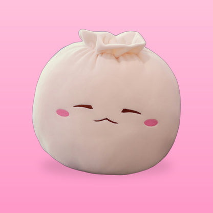 Cream bao bun plush pillow with sleepy closed eyes and pink cheeks on a pink background