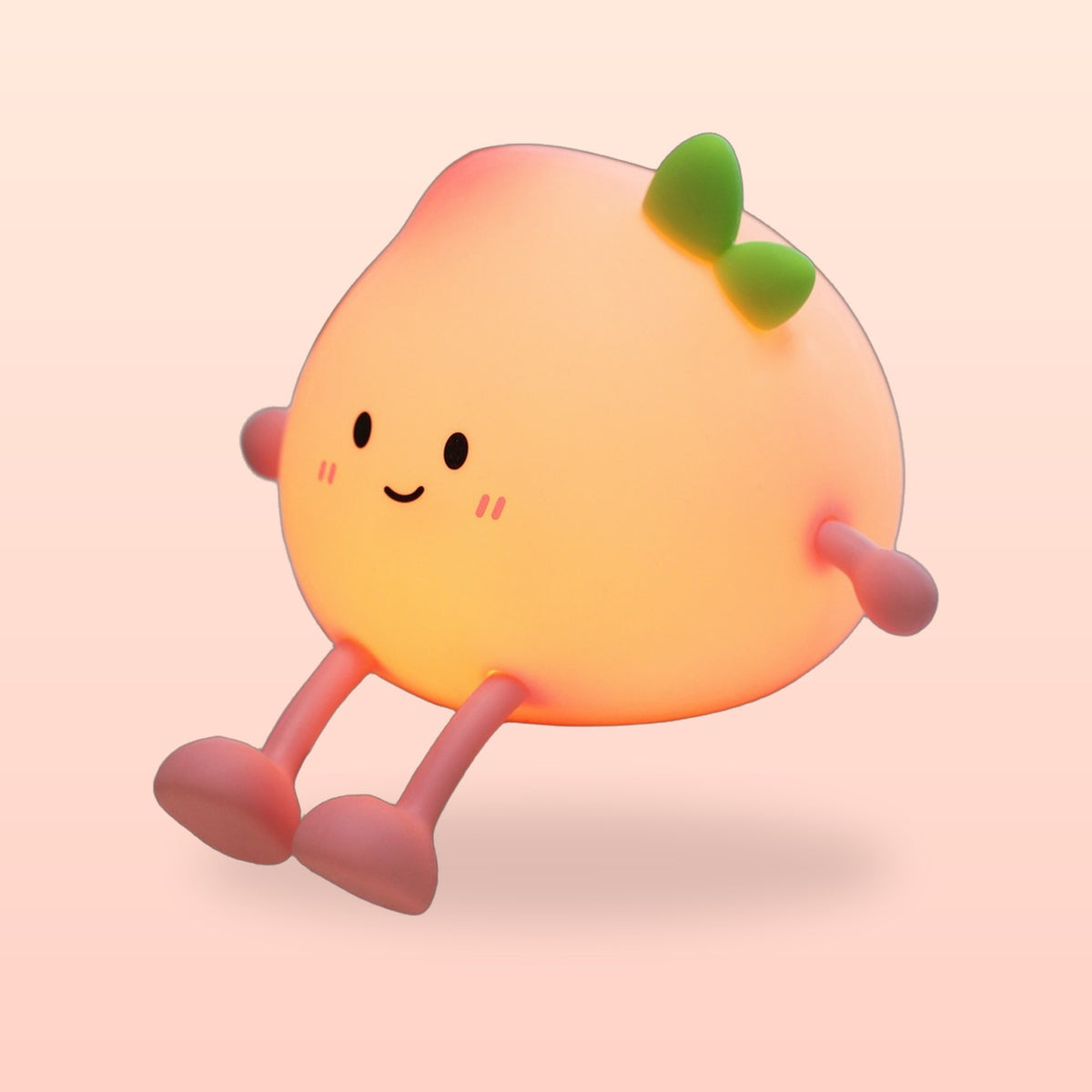 Peach night light switched on and glowing warm orange on a soft peach background