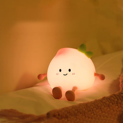 Peach night light glowing softly on a bed at night