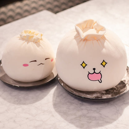 Small and large bao bun plush pillows side by side on a marble table to show the two sizes