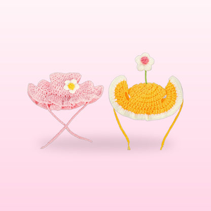 Pink blossom and yellow sunny egg crochet cat hats on a soft pink background