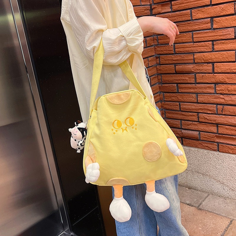 Person carrying the cheese tote bag on one shoulder