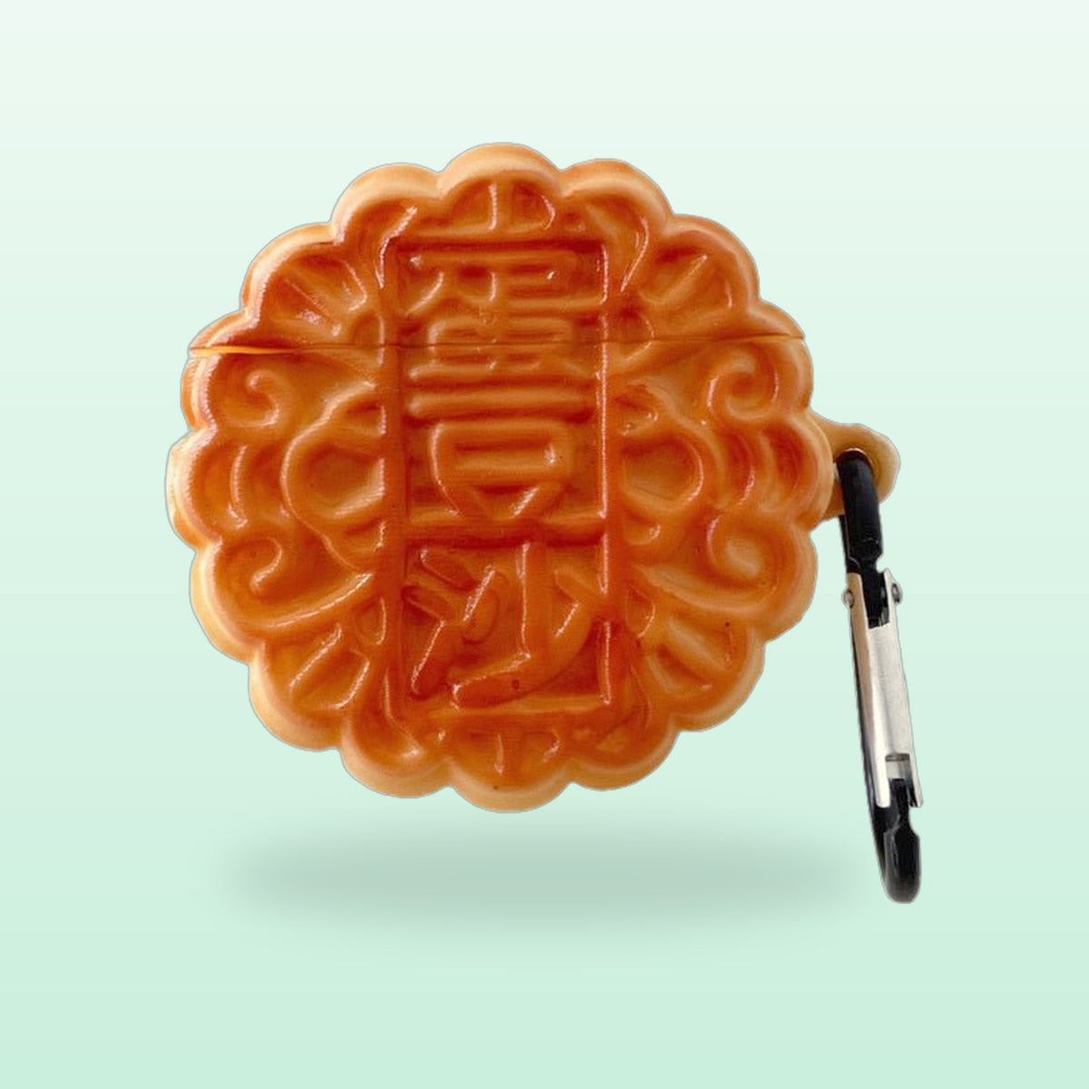 Mooncake silicone AirPods case with a black carabiner clip, on a mint green background