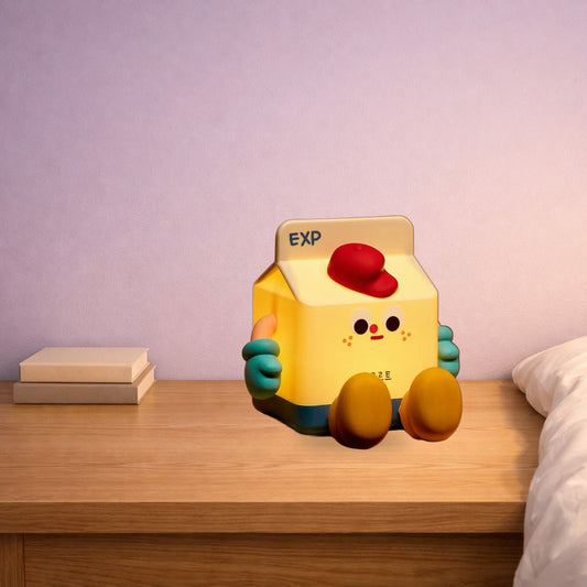 Milk carton night lamp glowing warm yellow on a bedside table
