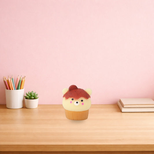 Bear cupcake mini squishy on a light oak desk