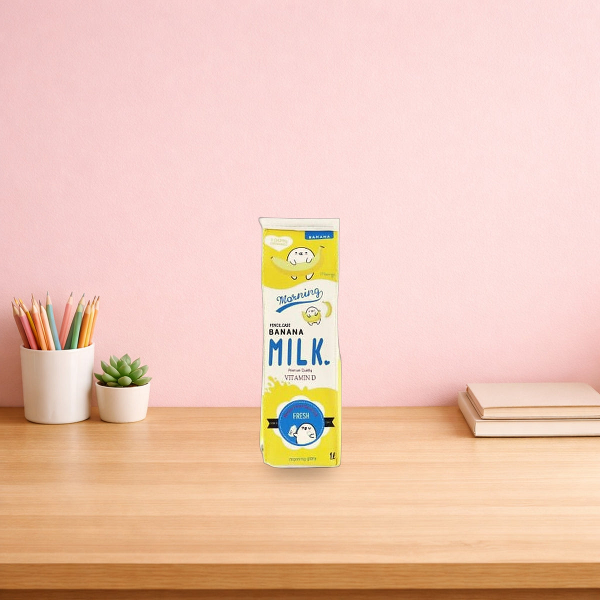 Yellow banana milk carton pencil case standing on a wooden desk