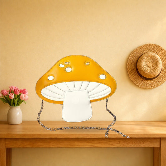 Yellow mushroom crossbody bag with its chain strap on an oak hall table