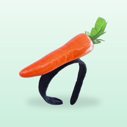 Carrot headband with an orange carrot on a black plush band, on a mint background
