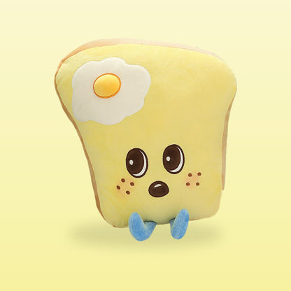 Egg toast plush pillow with a fried egg patch, freckles and blue feet, on a butter yellow background