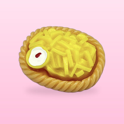 Fries basket miniature food fridge magnet in a little braided basket, on a pink background