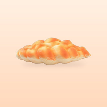 Plaited bread slow rise bread squishy on a soft peach background