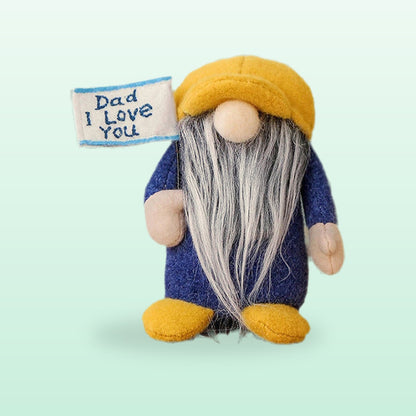 Dad I Love You plush gnome with a mustard hat, navy body and a grey beard, holding a flag, on a mint background