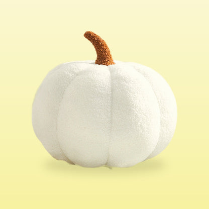Teddy pumpkin plush cushion, cream with a brown stem, on a butter yellow background