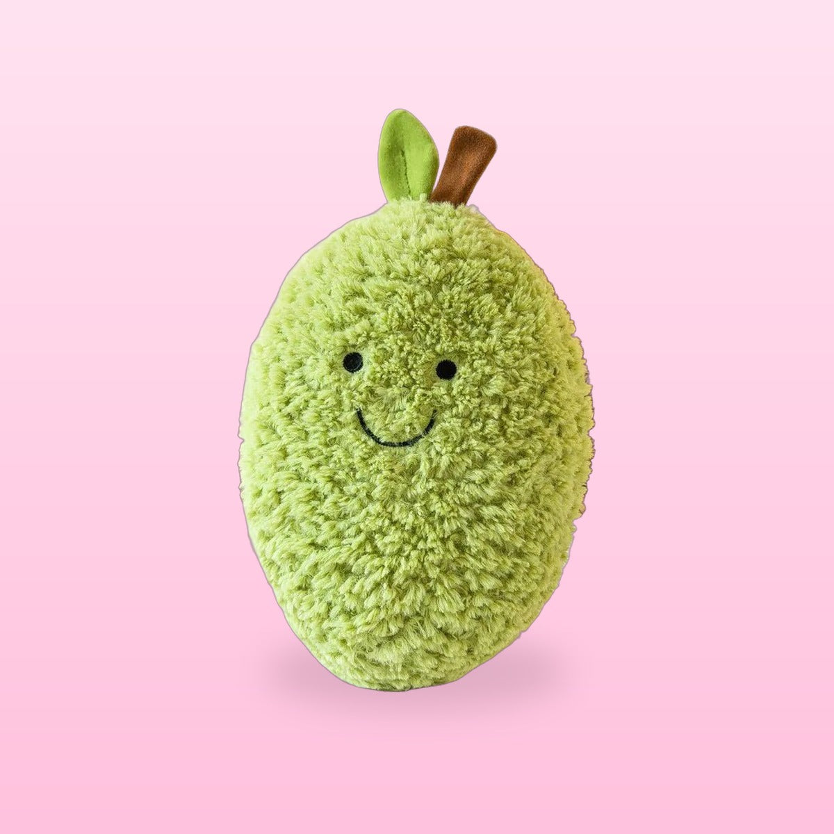 Fluffy green avocado plush with a leaf and a smiling face, on a bubblegum pink background