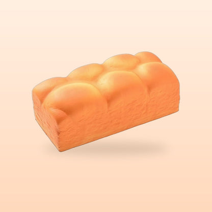 Bread loaf slow rise bread squishy on a soft peach background