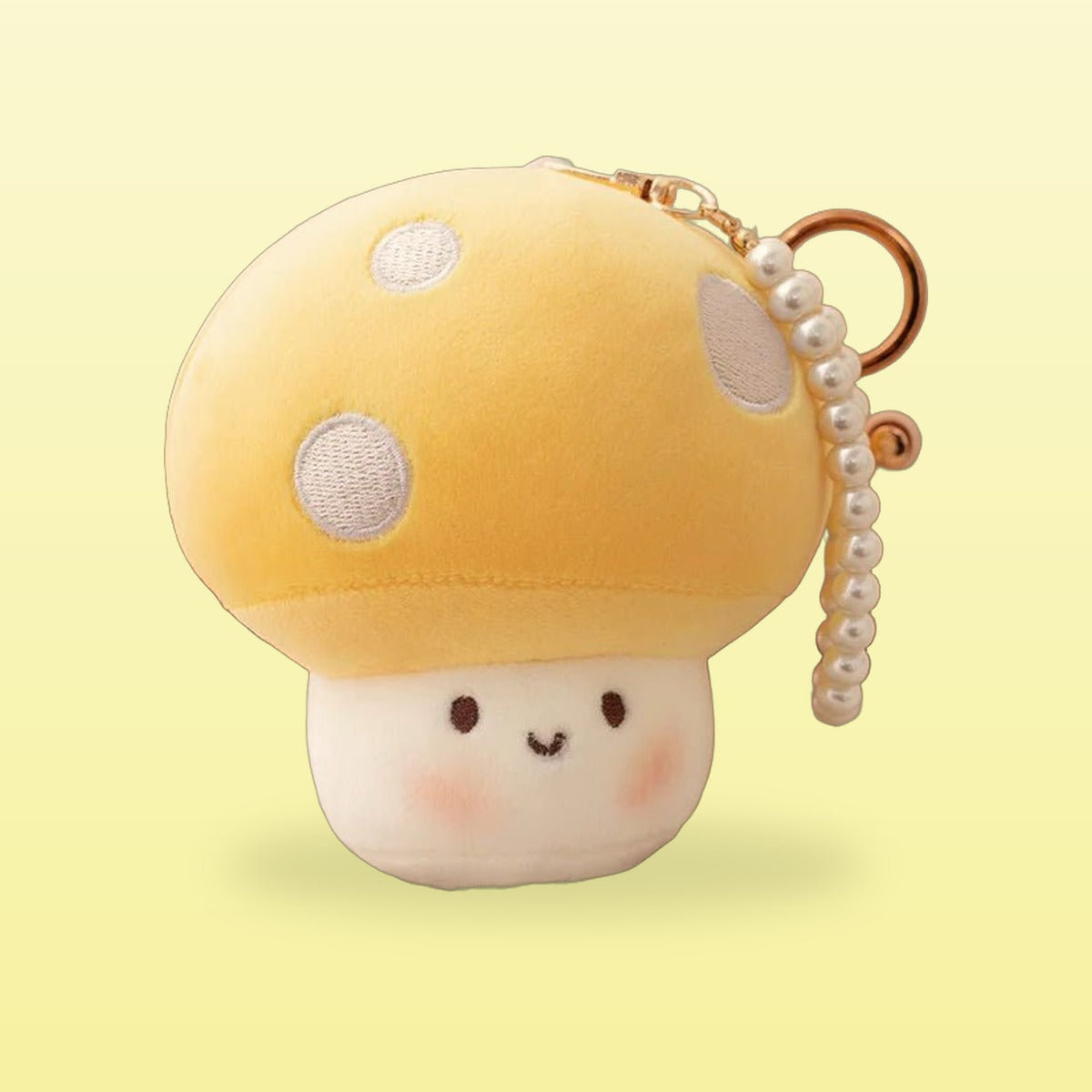 Yellow mushroom plush keychain with white spots, pearl strap and gold clip