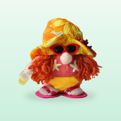 Sunglasses plush gnome with an orange hat, orange yarn hair, red sunglasses and a yellow swimsuit, on a mint background