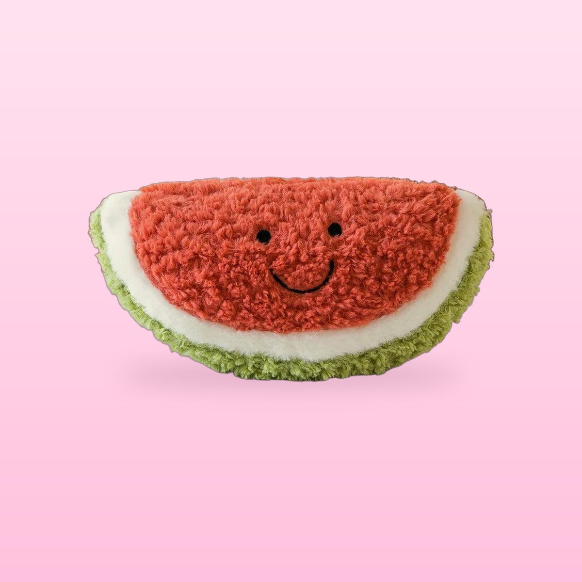 Fluffy watermelon slice plush with a green rind and a smiling face, on a bubblegum pink background