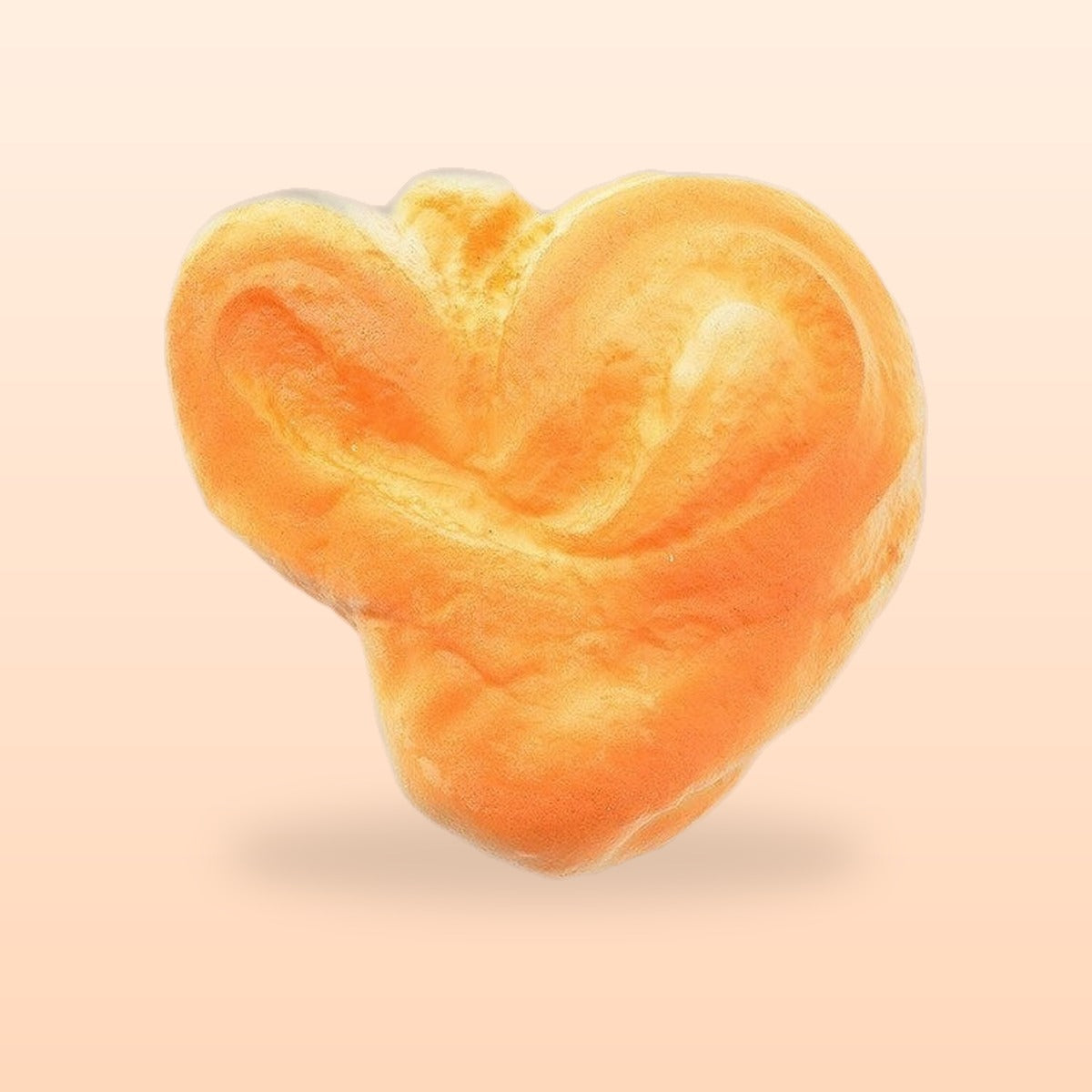 Heart pastry slow rise bread squishy, on a soft peach background