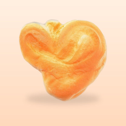 Heart pastry slow rise bread squishy, on a soft peach background