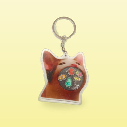Rock music cat acrylic keychain with a cat face and a metal ring, on a butter yellow background