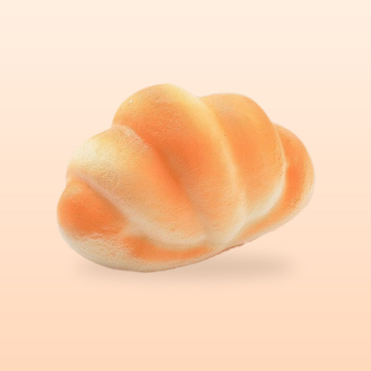 Plump croissant slow rise bread squishy, on a soft peach background