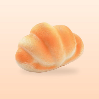 Plump croissant slow rise bread squishy, on a soft peach background